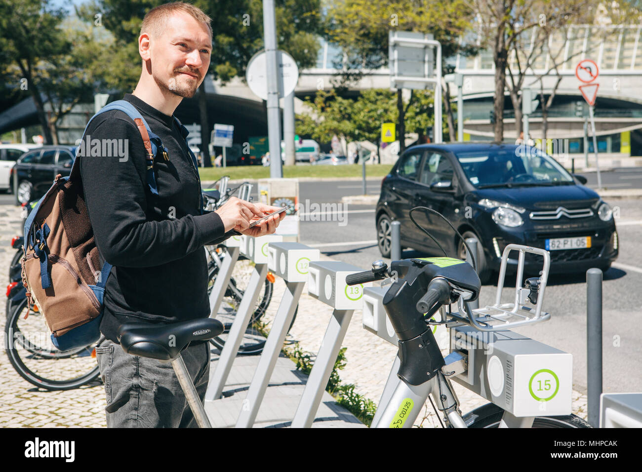 Portugal, Lisbon 29 april 2018: man rents bicycle using the mobile app on your phone Stock Photo