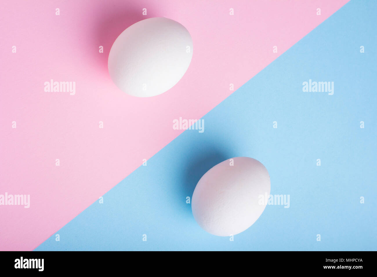 Two eggs on flat lay blue pink background Stock Photo