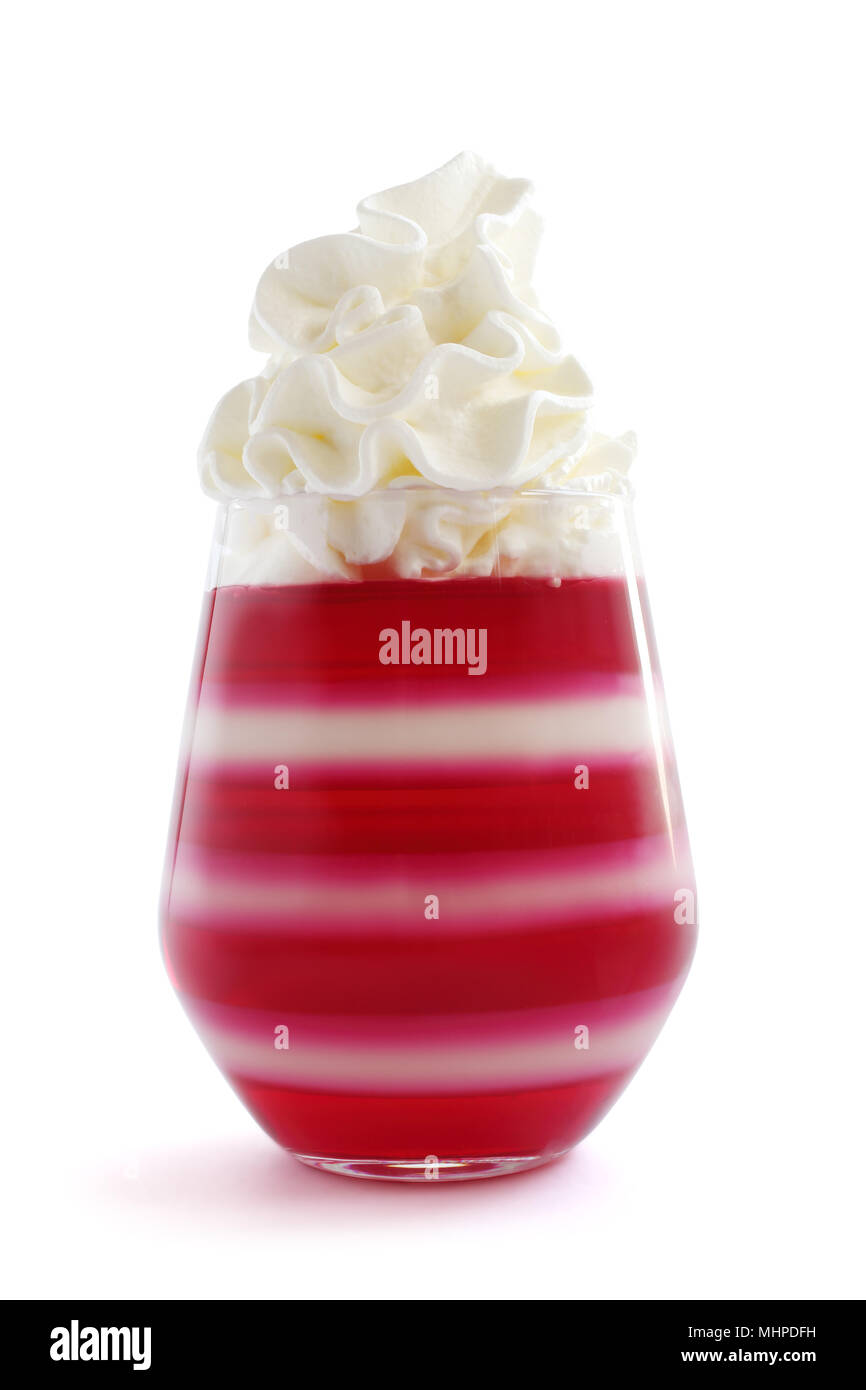 Red striped jello dessert in glass with whipped cream on top isolated