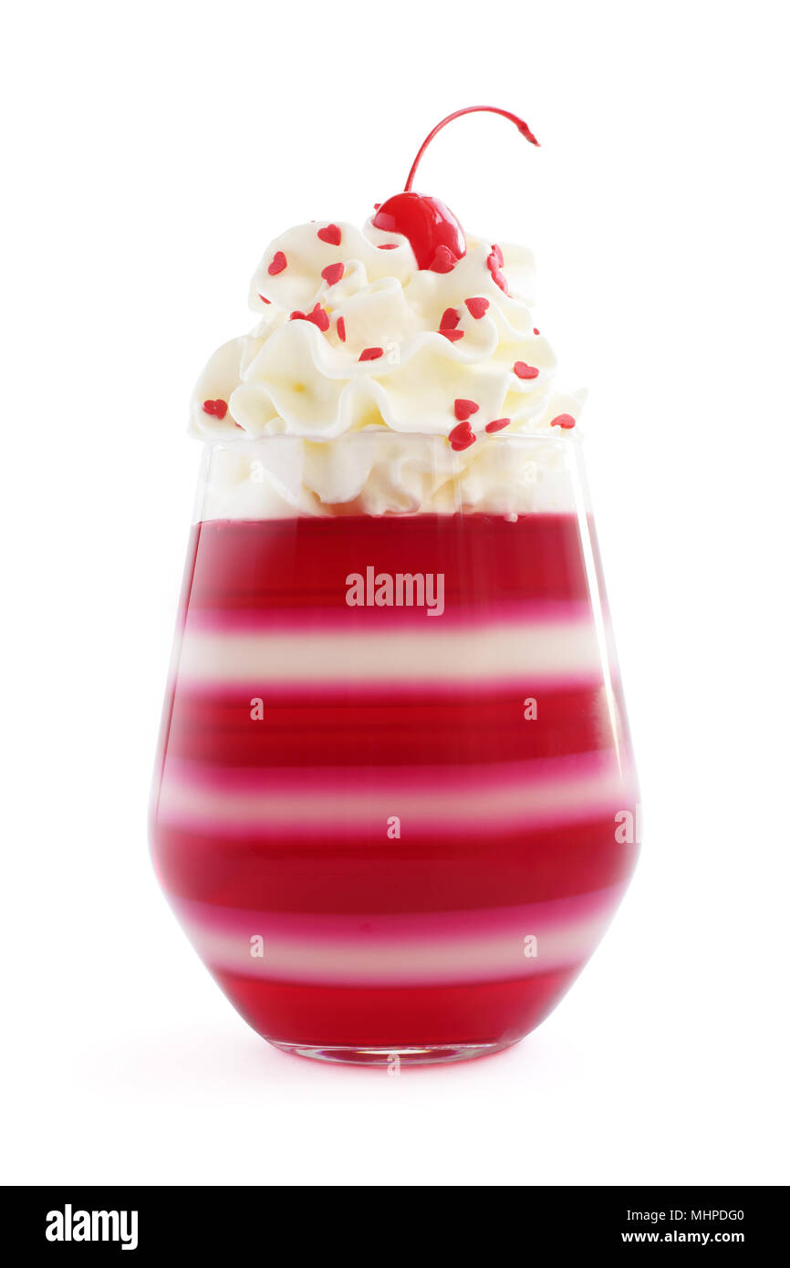Red striped jello dessert in glass with whipped cream, red candied