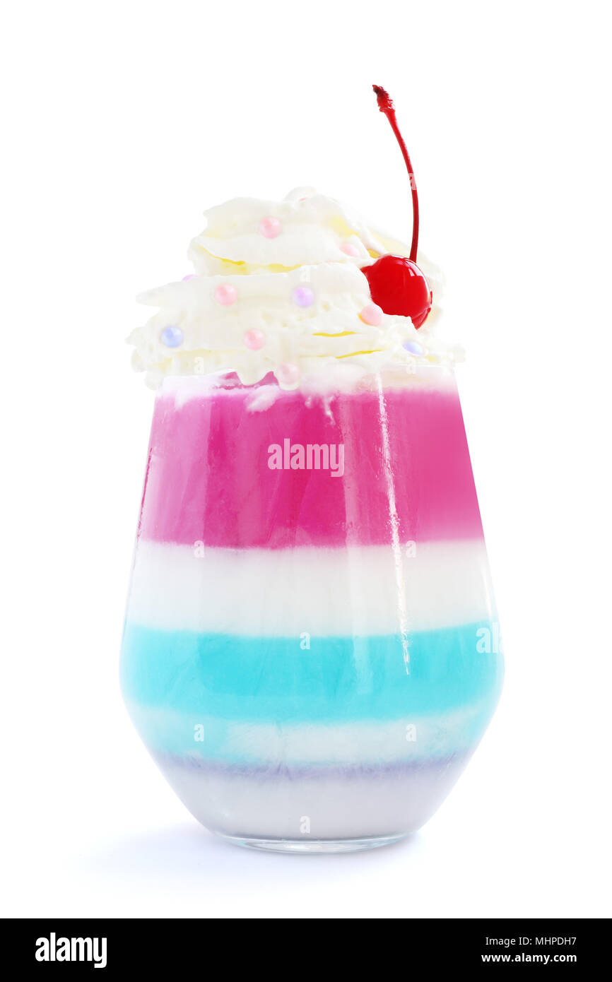 Striped jello dessert in glass with whipped cream and red candied