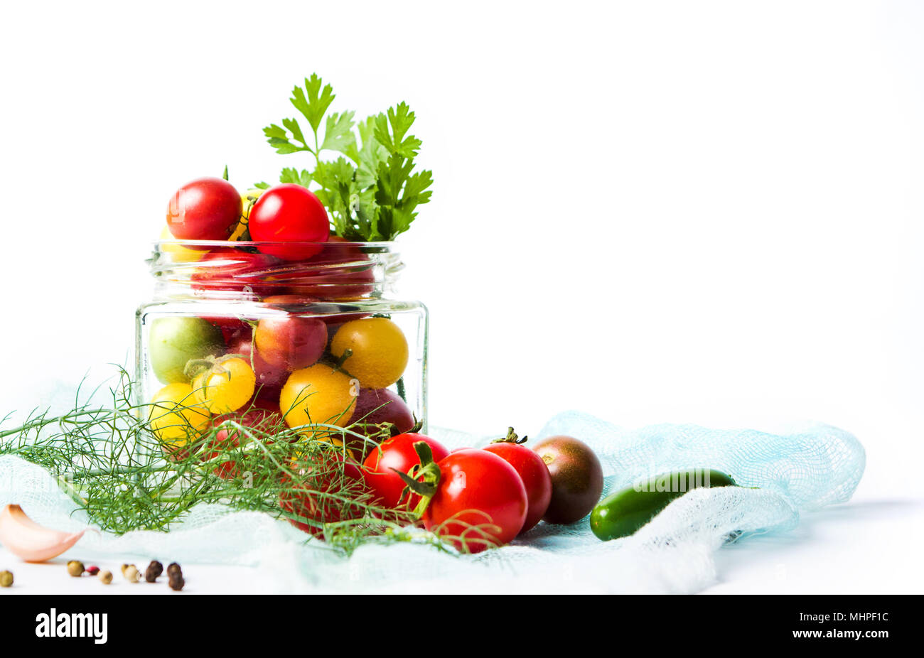 Red and yellow cherry tomatoes in a jar isolated on white Stock Photo ...