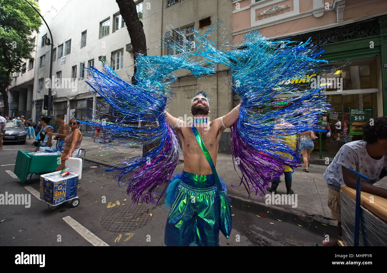South America, Brazil - February 10, 2018: Reveler dressed up as peacock has great fun during carnival time in Rio de Janeiro Stock Photo