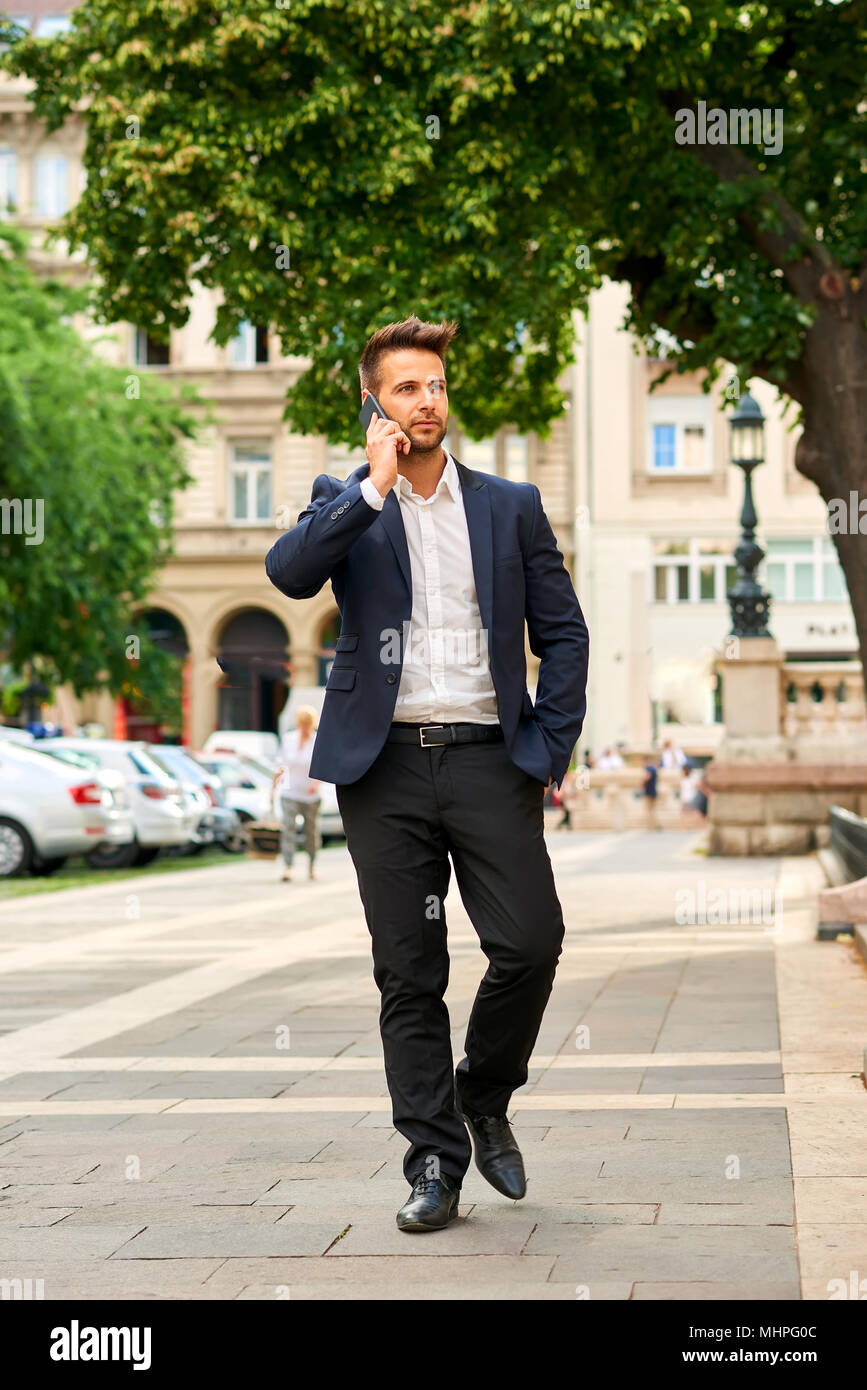 Stylish businessman in suit on sunny city street hi-res stock ...