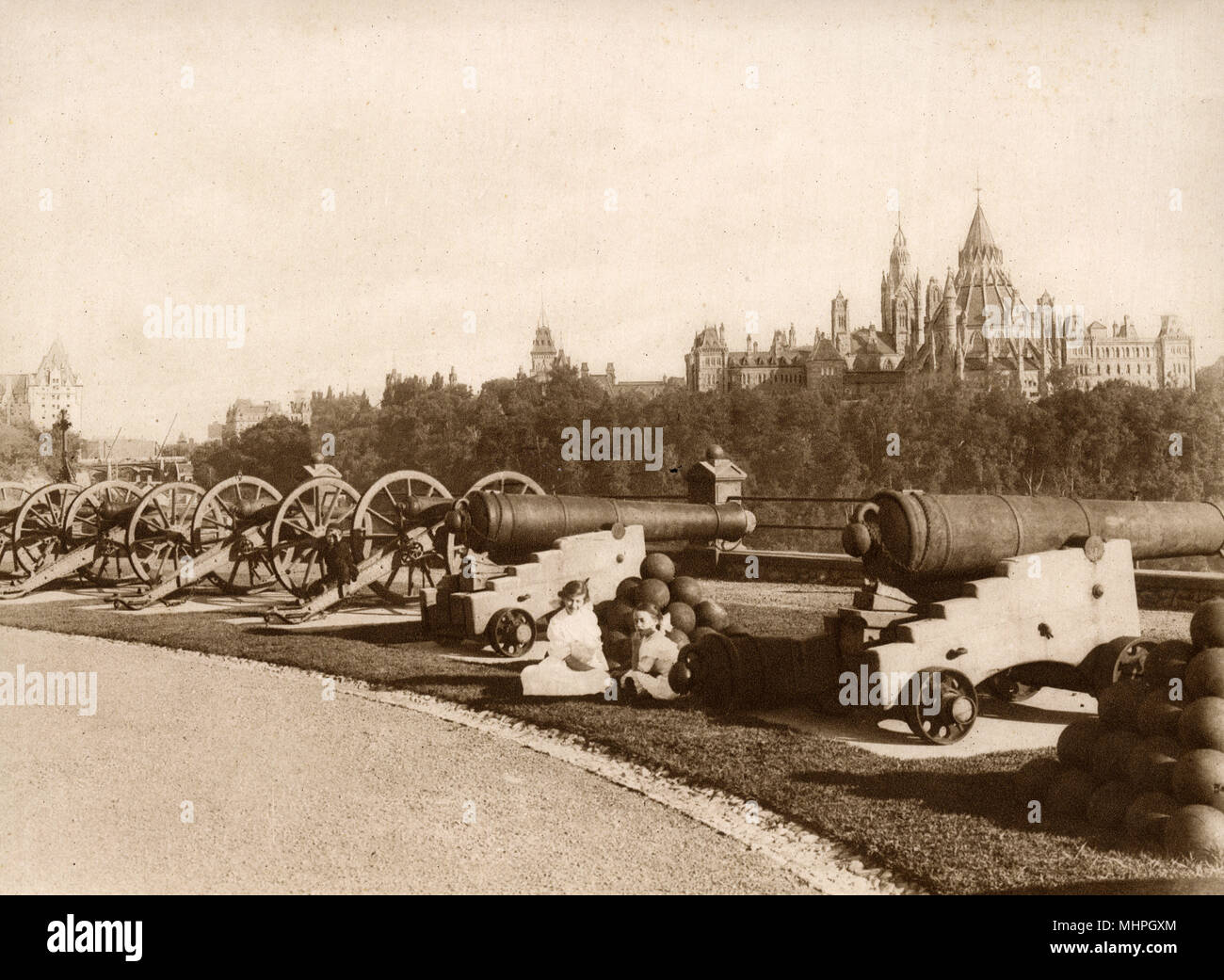 Nepean Point, with the Parliament Library in the distance on the right, Ottawa, Ontario, Canada. From this point royal salutes are fired, hence the line of cannons.      Date: circa 1910 Stock Photo