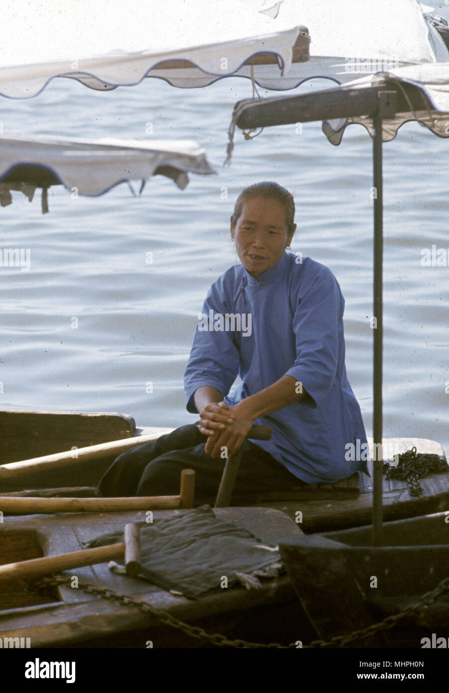 Woman in a boat, Hangchow (Hangzhou), China.     Date: circa 1962 Stock Photo