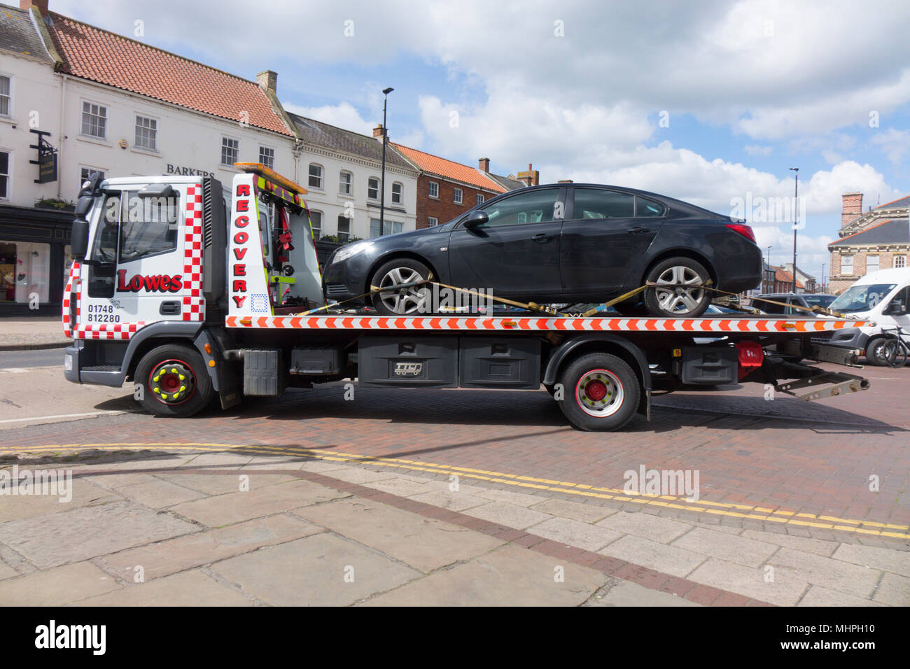 Vehicle breakdown a Vauxhall Insignia automobile being removed by a recovery vehicle from Lowes Recovery Stock Photo
