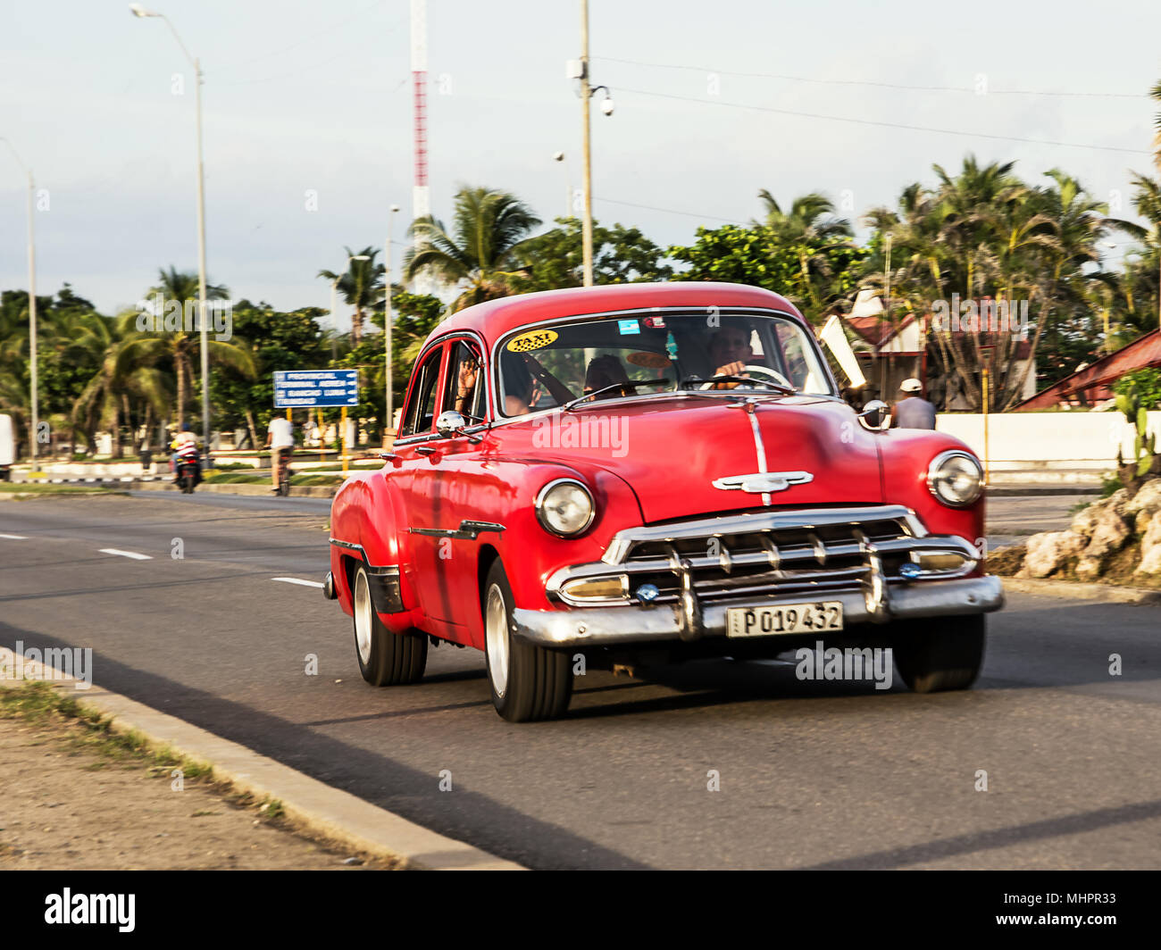 Cienfuegos, Cuba - December 7, 2017: Old red American car on the Cienfuegos Malecon Stock Photo