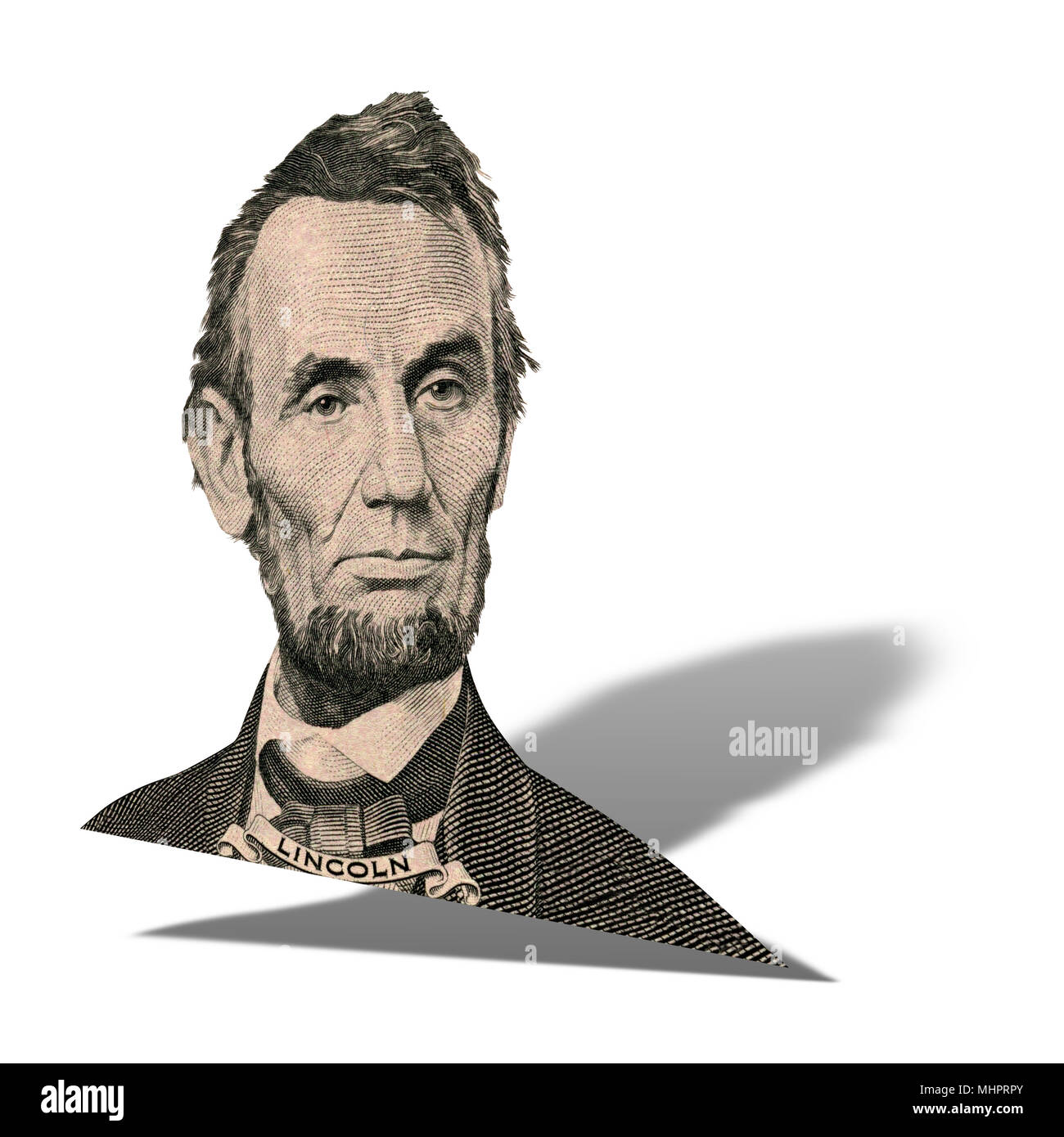 Portrait of former U.S. president Abraham Lincoln as he looks on five dollar bill obverse. Photo at an angle of 15 degrees, with a shadow. Stock Photo
