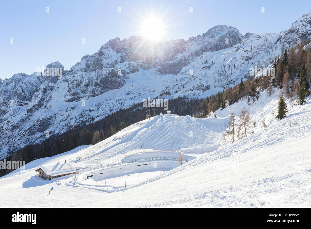 Skier on a ski trail at the foothills of the north face of the ...