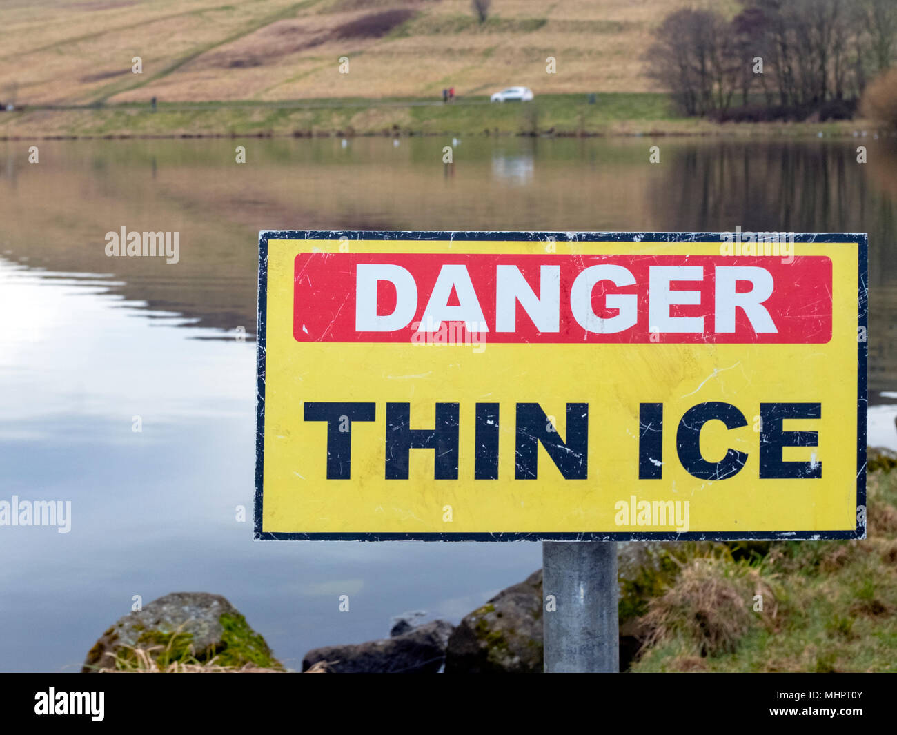 Danger Thin Ice sign at Dunsapie Loch, Arthurs Seat, Edinburgh, Scotland, United Kingdom. Stock Photo