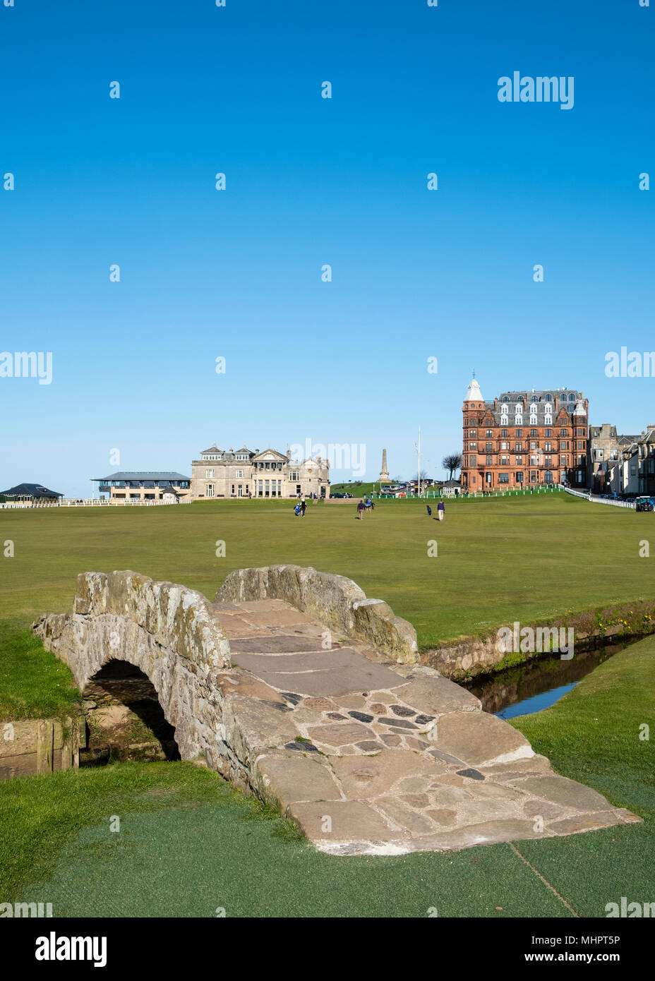 View of 18th hole at Royal and Ancient Golf Club (R&A) and famous old Swilken Bridge over Swilken Burn on 18th Hole at Old Course St Andrews Stock Photo