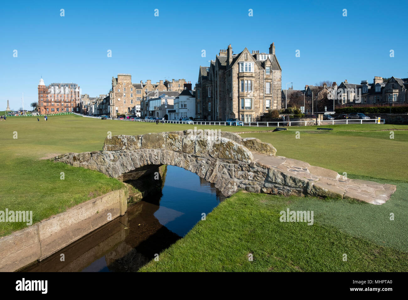 View of 18th hole at Royal and Ancient Golf Club (R&A) and famous old Swilken Bridge over Swilken Burn on 18th Hole at Old Course St Andrews Stock Photo