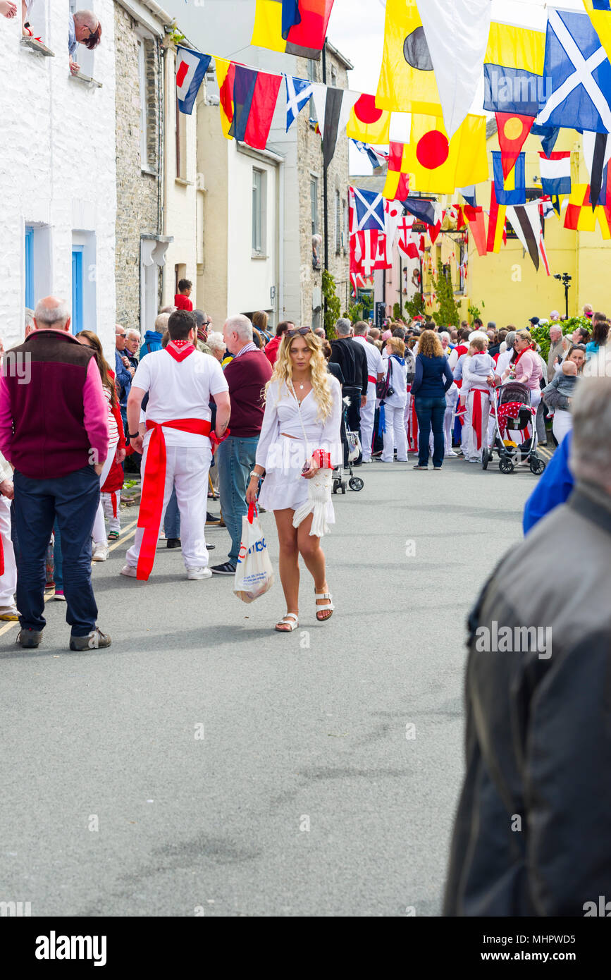 Editorial: Unknown members of the public, potential logos and signage. Padstow, Cornwall, UK 01/05/2018. Padstow residents parade through the streets  Stock Photo