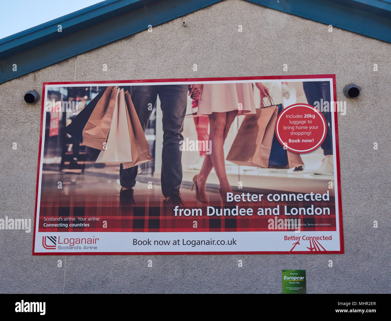 Details of a Loganair Advertising Poster on the side wall of an Airport building at Dundee Airport in Angus, Scotland. Stock Photo