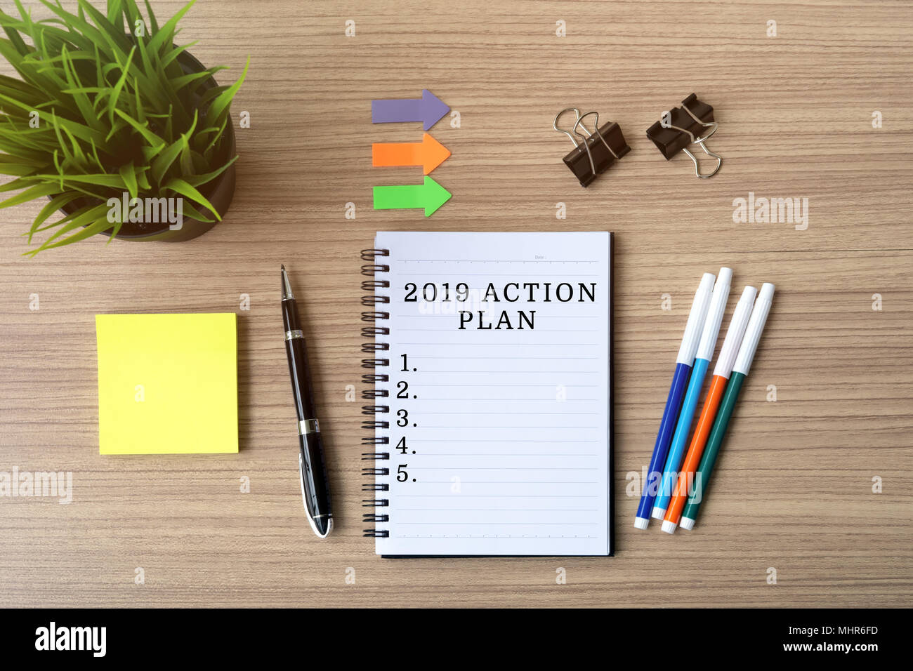2019 Action Plan on notepad, flat lay business office desk. Stock Photo