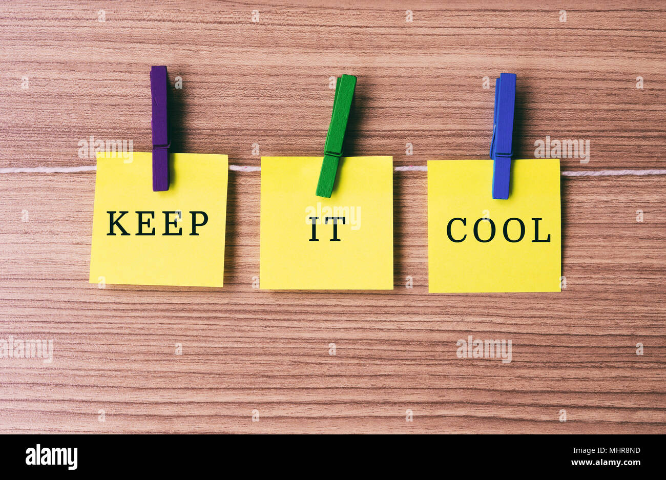 Inspirational quote - Keep it cool on notes hanging by clothespins Stock Photo