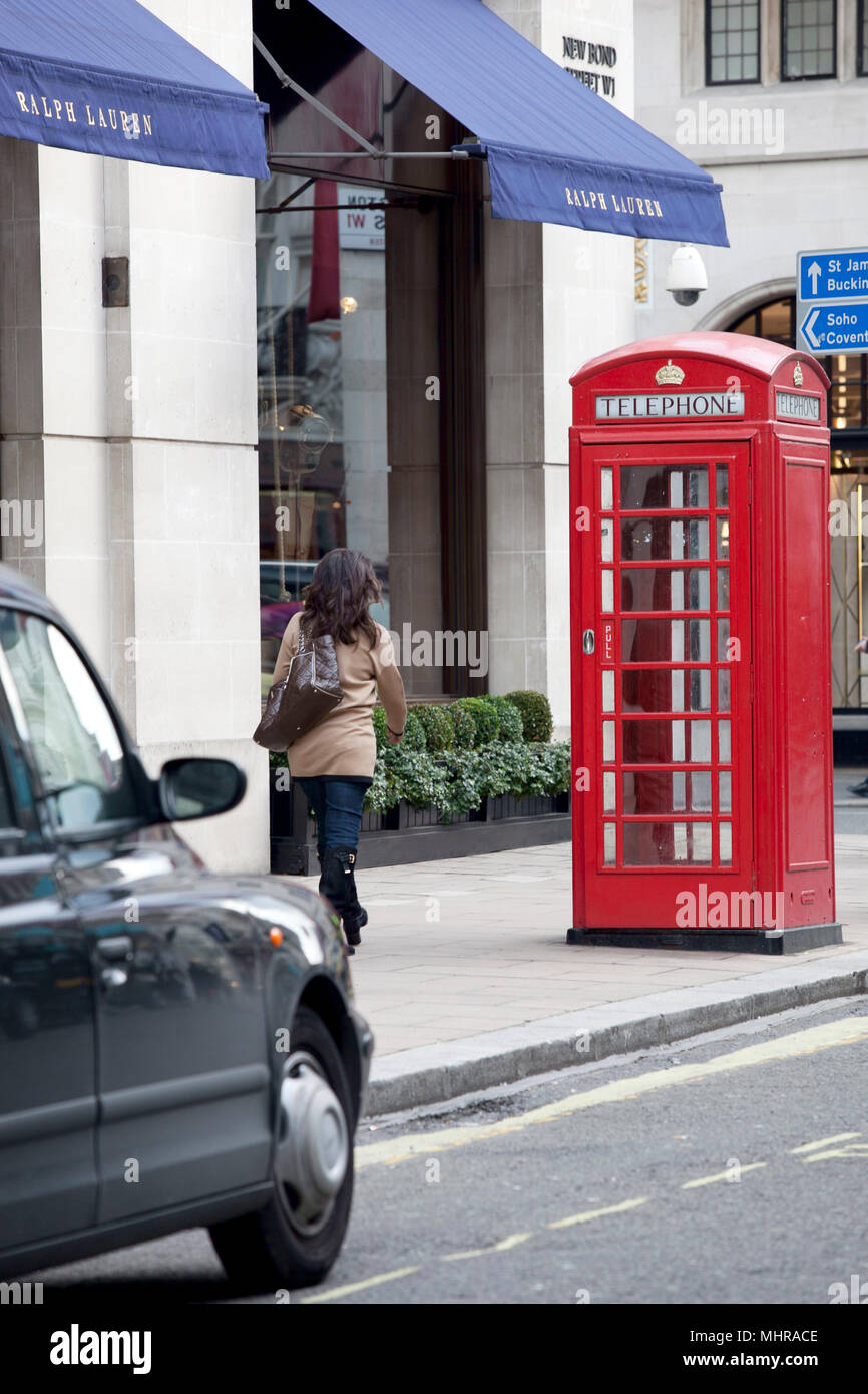 Telephone box in london street with black cab in the west end Stock Photo