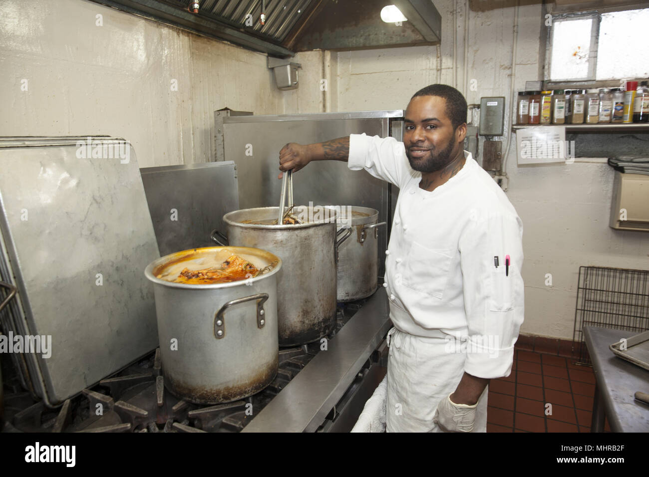 Chef at a senior citizen center prepares lunch on the Lower East Side, New York City. Stock Photo