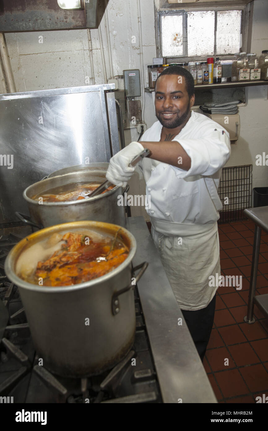 Chef at a senior citizen center prepares lunch on the Lower East Side, New York City. Stock Photo