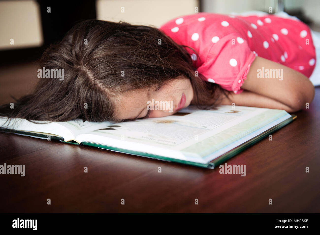 Tired little girl sleeping on book,istanbul Stock Photo Alamy