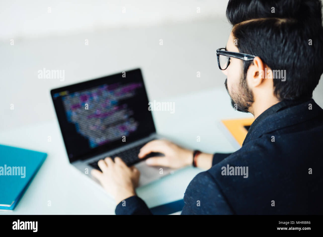 Indian software developer working on computer at his office table Stock ...