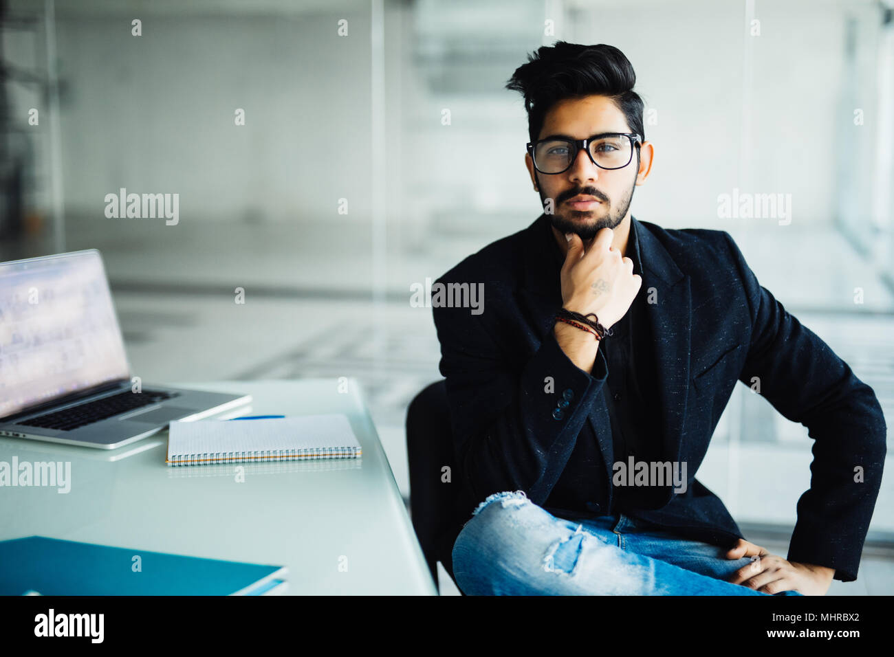 Young dreamy businessman in suit thinking of business vision outlook planning future project idea at work with laptop, successful happy contemplative  Stock Photo