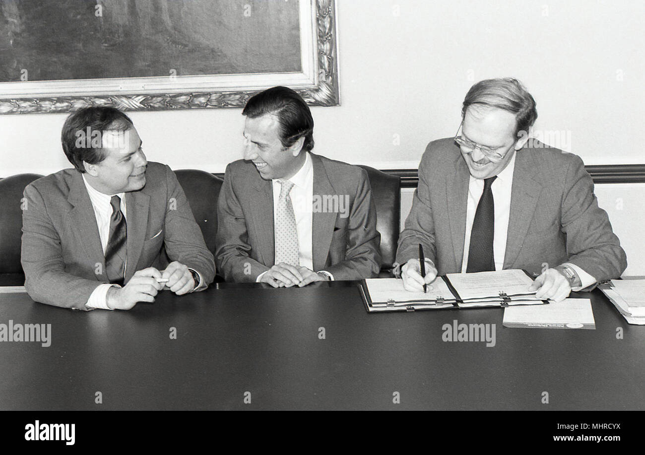 Snapshot of men signing documents Stock Photo - Alamy