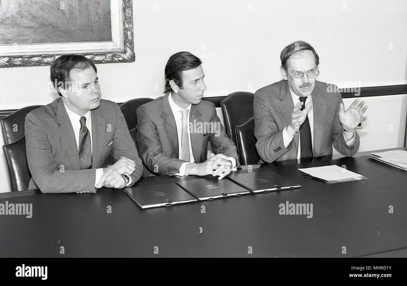 Black and white photo of three men sitting at a table Stock Photo - Alamy