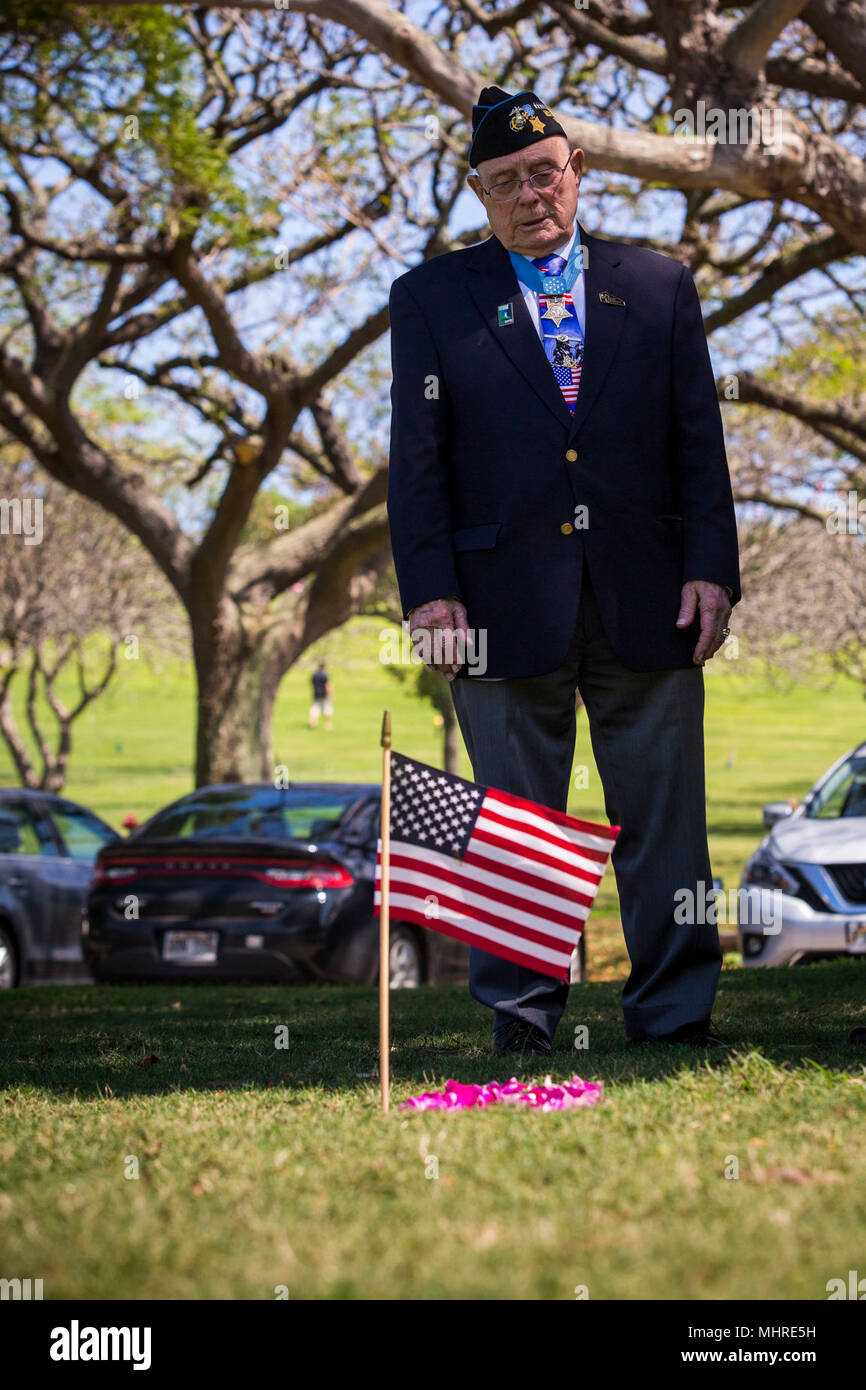 U.S. Marine Corps Chief Warrant Officer 4 Hershel 'Woody' Williams (Ret.) visits the grave of his friend Cpl. Vernon J. Walthers who was killed during the Battle of Iwo Jima, National Memorial Cemetary of the Pacific, Honolulu, HI, March 17, 2018. Williams traveled to Oahu to participate in various events and visit the graves of World War II veterans that made the ultimate sacrifice. (U.S. Marine Corps Stock Photo