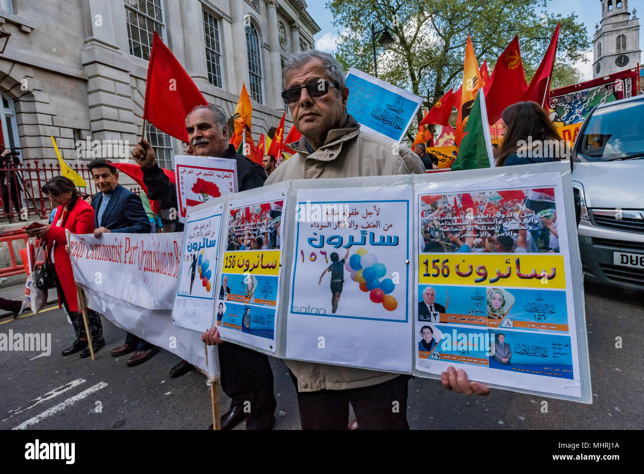 May 1, 2018 - A rally in Trafalgar Square including many .from London's international and migrant communities celebrates .International Workers Day. Some held flags and banners on the plinth of .Nelson's Column  while others listened to the speeches by a number of .trade unionists and activists and included a short silence in memory of .Mehmet Aksoy who was killed in Syria whilst filming with Kurdish .fighters and had spoken for the Kurds at previous events. At the end of .the rally there was a speech by Brixton Ritzy trade unionist Kelly .Rogers victimised by Picturehouse and the various prec Stock Photo