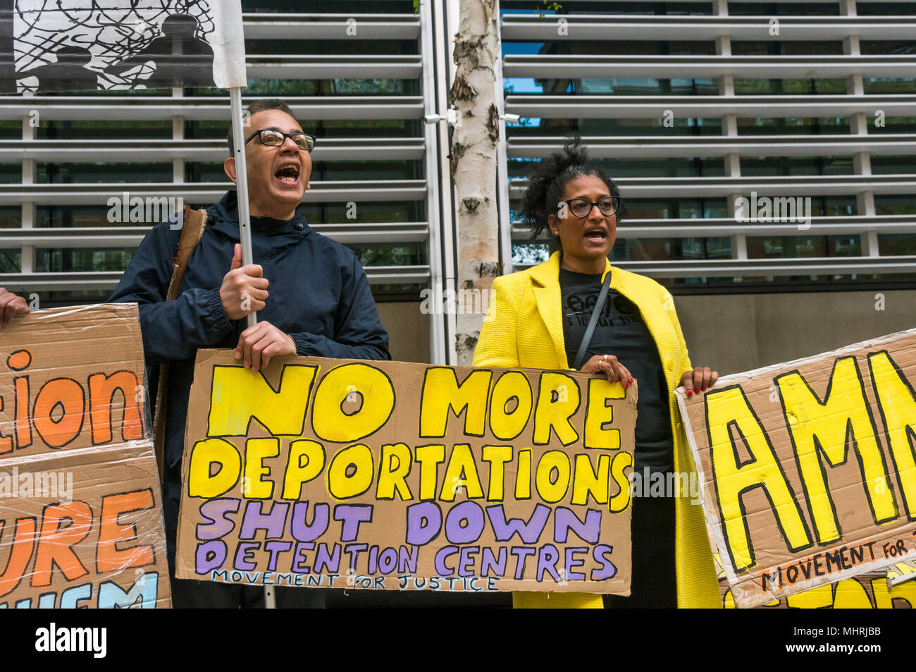 May 1, 2018 - London, UK. 1st May 2018. Protesters hold posters and a banner at the Home Office called by Movement for Justice calling for an end to immigration charter flights. The protest was called as the Home Office intends to carry out a mass deportation to Jamaica in the middle of the Windrush scandal including members of the Windrush generation. The protest at the Home Office and later at the Jamaican High Commission called for an end to these mass deportations, which have led to a rounding up of many who are in this country legally but whose cases are still disputed by the Home Office. Stock Photo