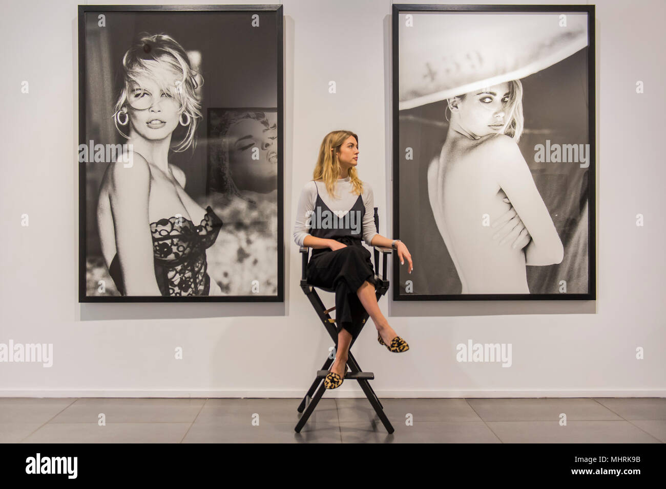 London, UK. 3rd May 2018. Claudia Schiffer, 1989, and Parasol, 1990 - Ladyland by Ellen von Unwerth, female fashion photographer, a new exhibition of over 40 of her most famous photographs from the 1990s to present day at London’s Opera Gallery in Mayfair. Credit: Guy Bell/Alamy Live News Stock Photo