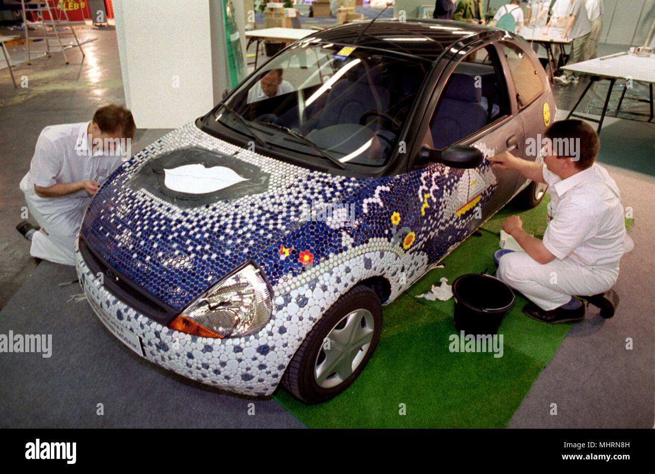with thousands of mosaic stones, two aspiring tiler masters decorate a Ford  Ka at the Handwerks-Messe NRW on 1.6.1999 in Koln. The focal points of the  fair are the topics of construction,