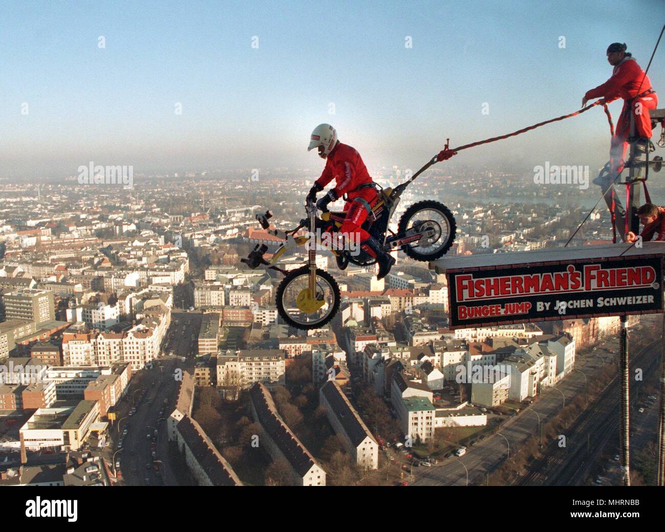 From 130 meters high Jochen Schweitzer jumps on his cross machine, hanging on a bungee rope only, on 15.1.1997 from the Hamburg TV tower. The hitherto unique stunt on a 100 kilogram motorcycle is to be advertised for the Hamburg Motorcycle Days, which take place from 24 to 26 January at the exhibition center. | usage worldwide Stock Photo