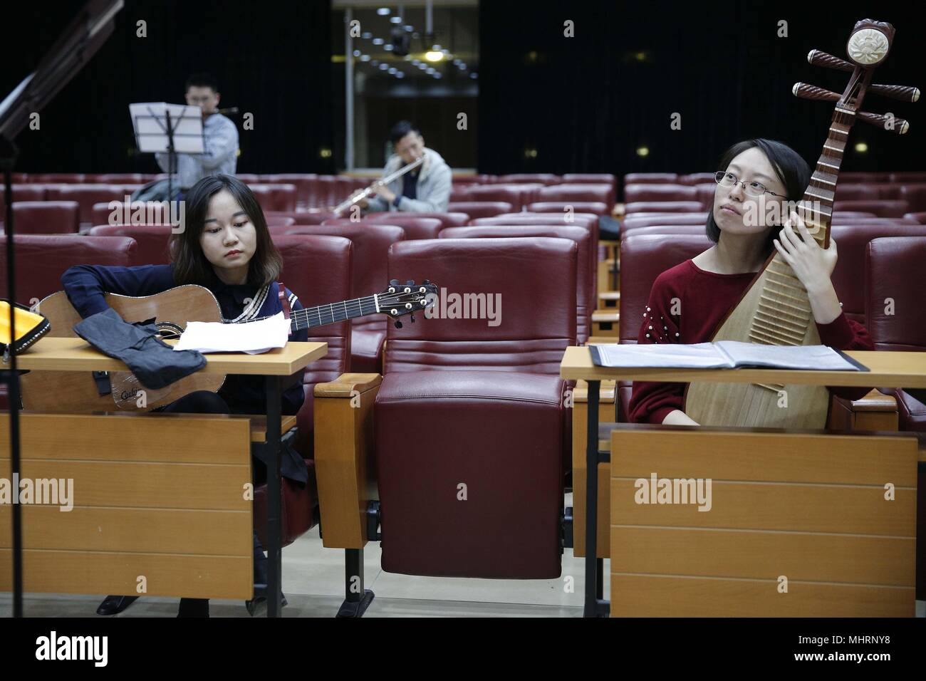 (180503) -- BEIJING, May 3, 2018 (Xinhua) -  Members of the 'Xieyun'orchestra attend a rehearsal at Peking Union Medical College (PUMC) in Beijing, capital of China, April 13, 2018. In 2015, Peking Union Medical College Hospital doctors and PUMC students launched the 'Xieyun' orchestra. Every month, members of 'Xieyun' would voluntarily stage one or two musical performances for patients, their families, and other medical workers. The orchestra was widely appreciated by its audiences for its performances and the members' concern and love for the patients. (Xinhua/Zhang Yuwei) (lb) (zt) Stock Photo