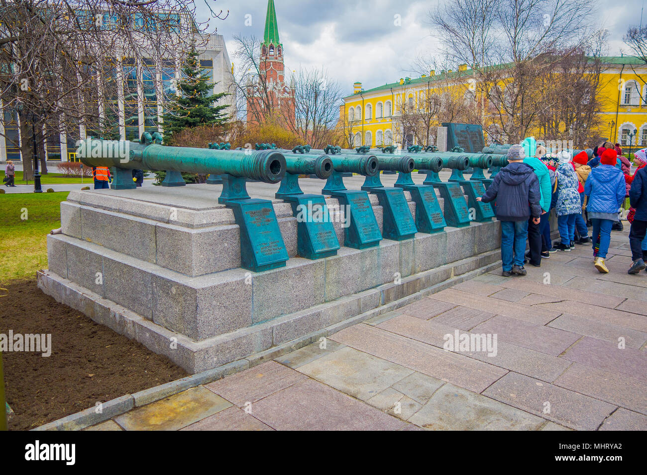 MOSCOW, RUSSIA- APRIL, 24, 2018: People walking close to old military trunks of ancient cannons. Collection incorporates old Russian and foreign cannons of XVI-XIX centuries shown in the Moscow Kremlin Stock Photo