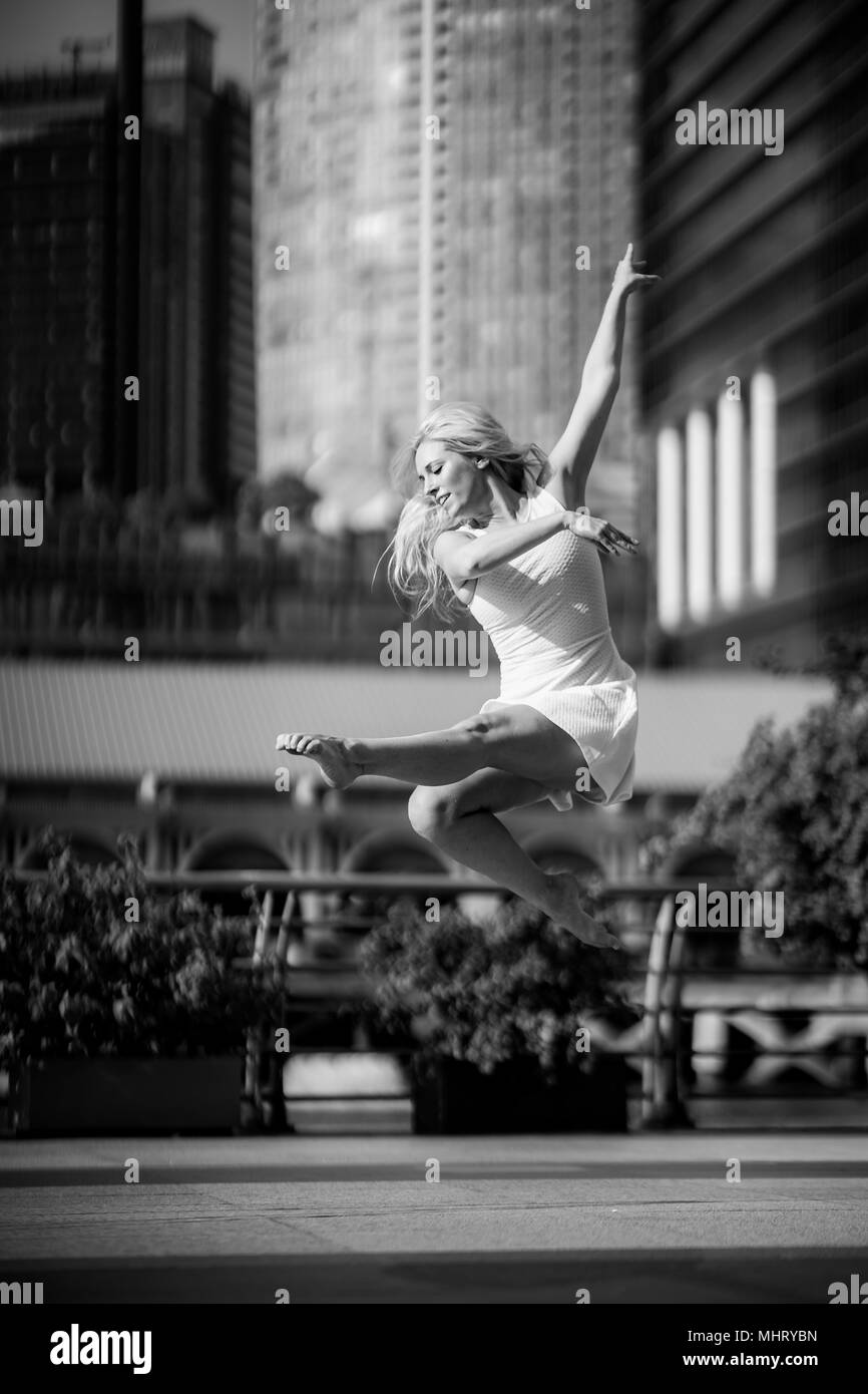 Beautiful Young Girl Dancing on a bridge Stock Photo