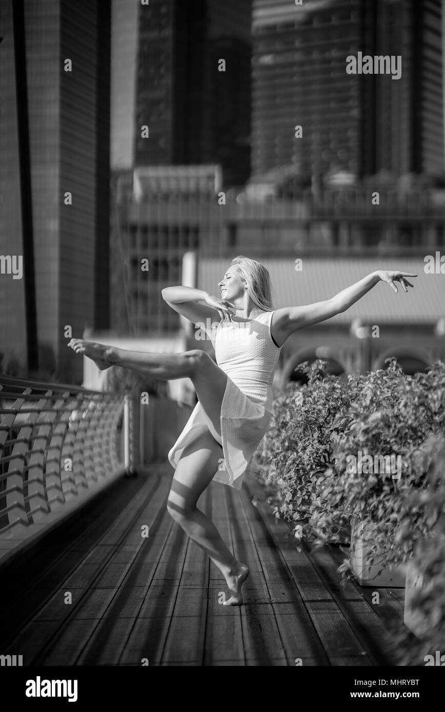 Beautiful Young Girl Dancing on a bridge Stock Photo