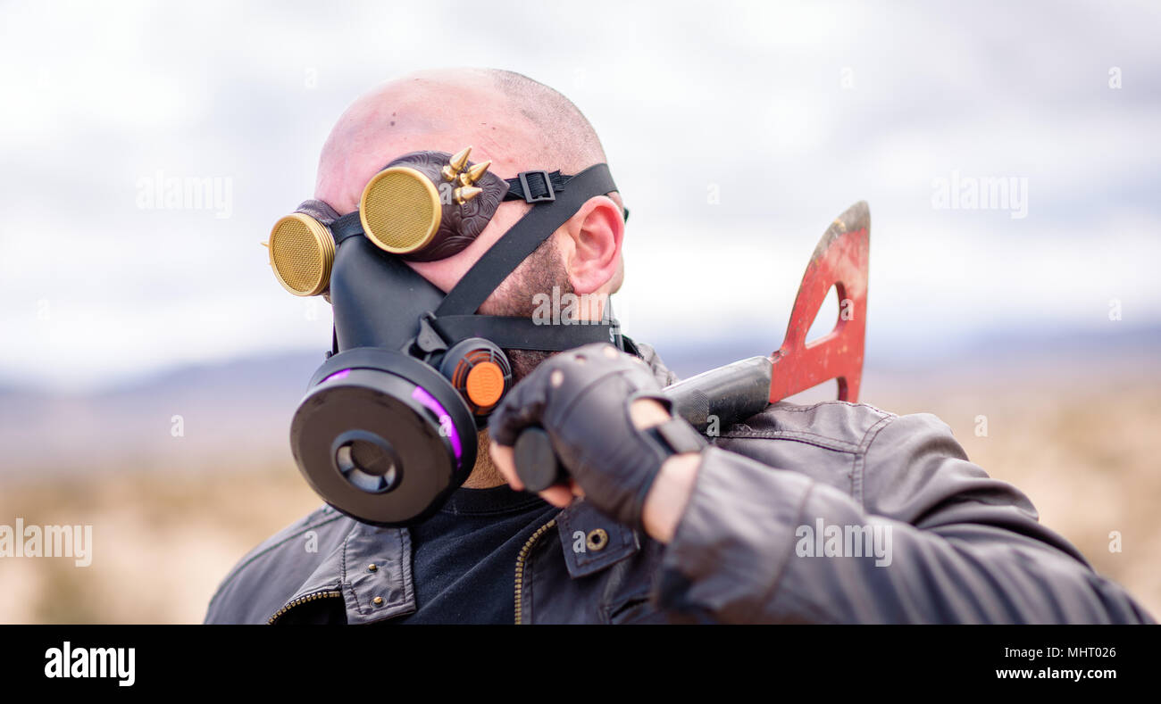 In a post-apocalyptic desert wasteland, a Queen of the Apocalypse leads her militia against the enemy. Armed to the teeth, who will win? Post-Apocalyp Stock Photo