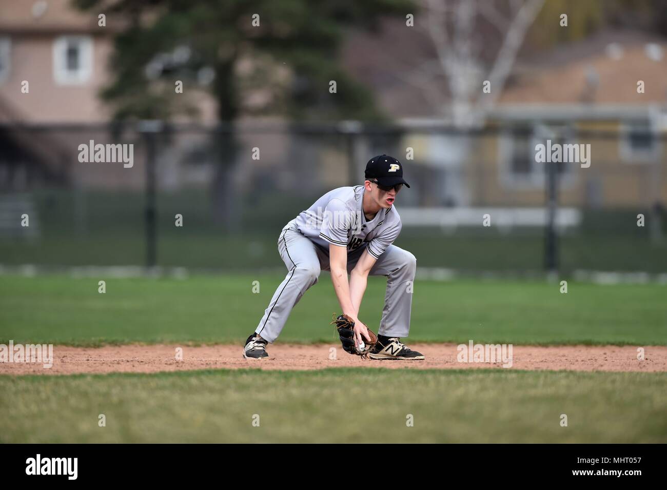 Second baseman fielding a ground ball prior to throwing on to first bsee to retire the batter. USA. Stock Photo