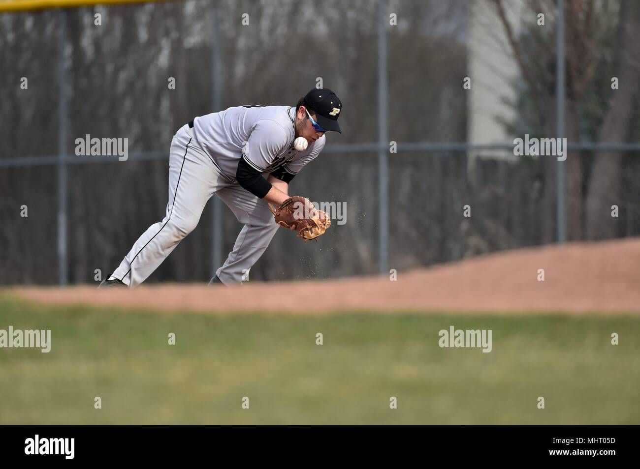 First baseman bobbling a ground ball for an error. USA. Stock Photo