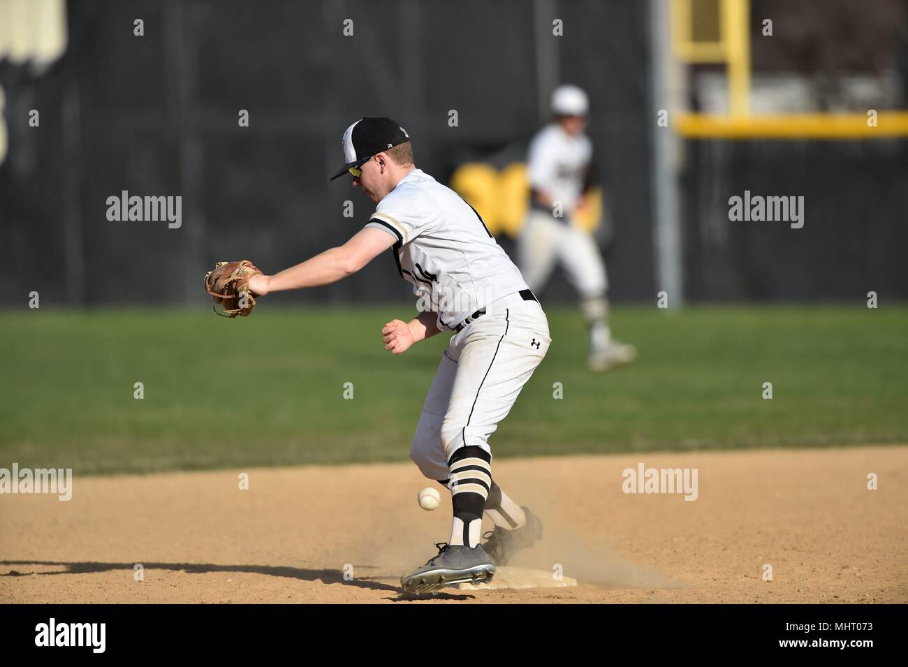 Second baseman drops a throw from the shortstop negating a force out at second.. USA. Stock Photo