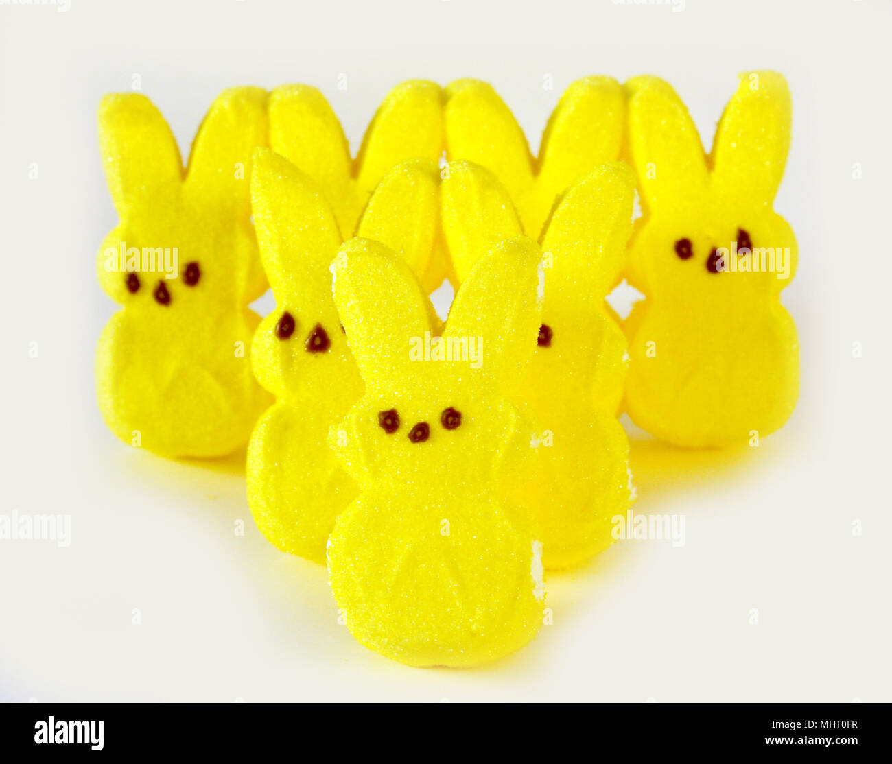 Yellow marshmallow bunnies, form a triangle, isolated on a white background. Stock Photo