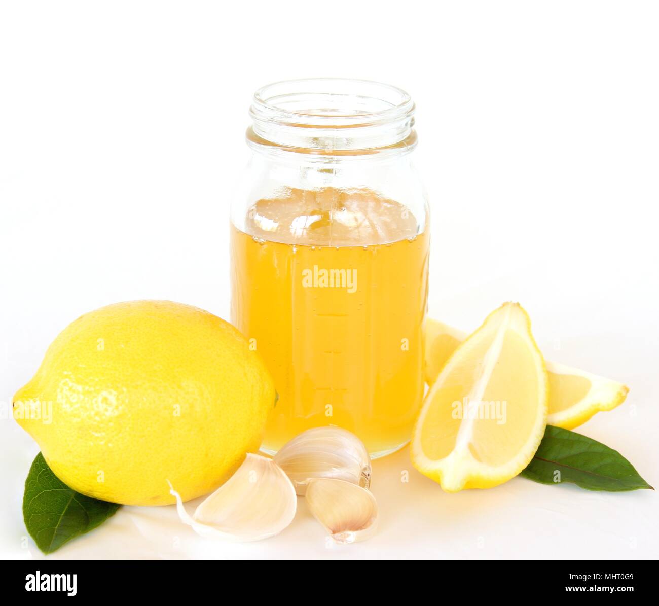 Lemon, honey, garlic, cold and flu remedy, isolated on a white background. Stock Photo