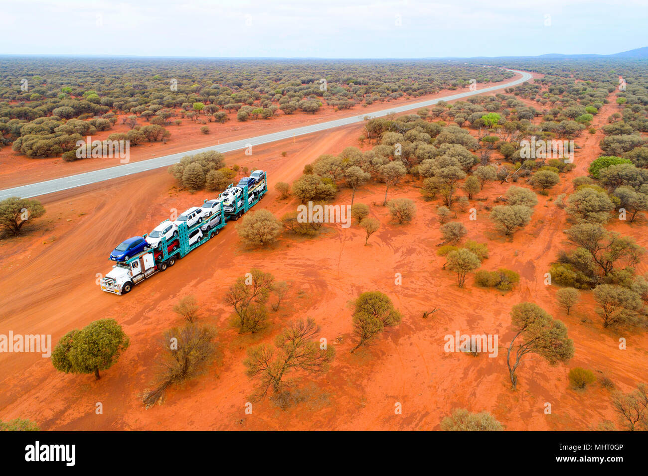 Motor vehicle transport truck on a red dirt road alongside the Great