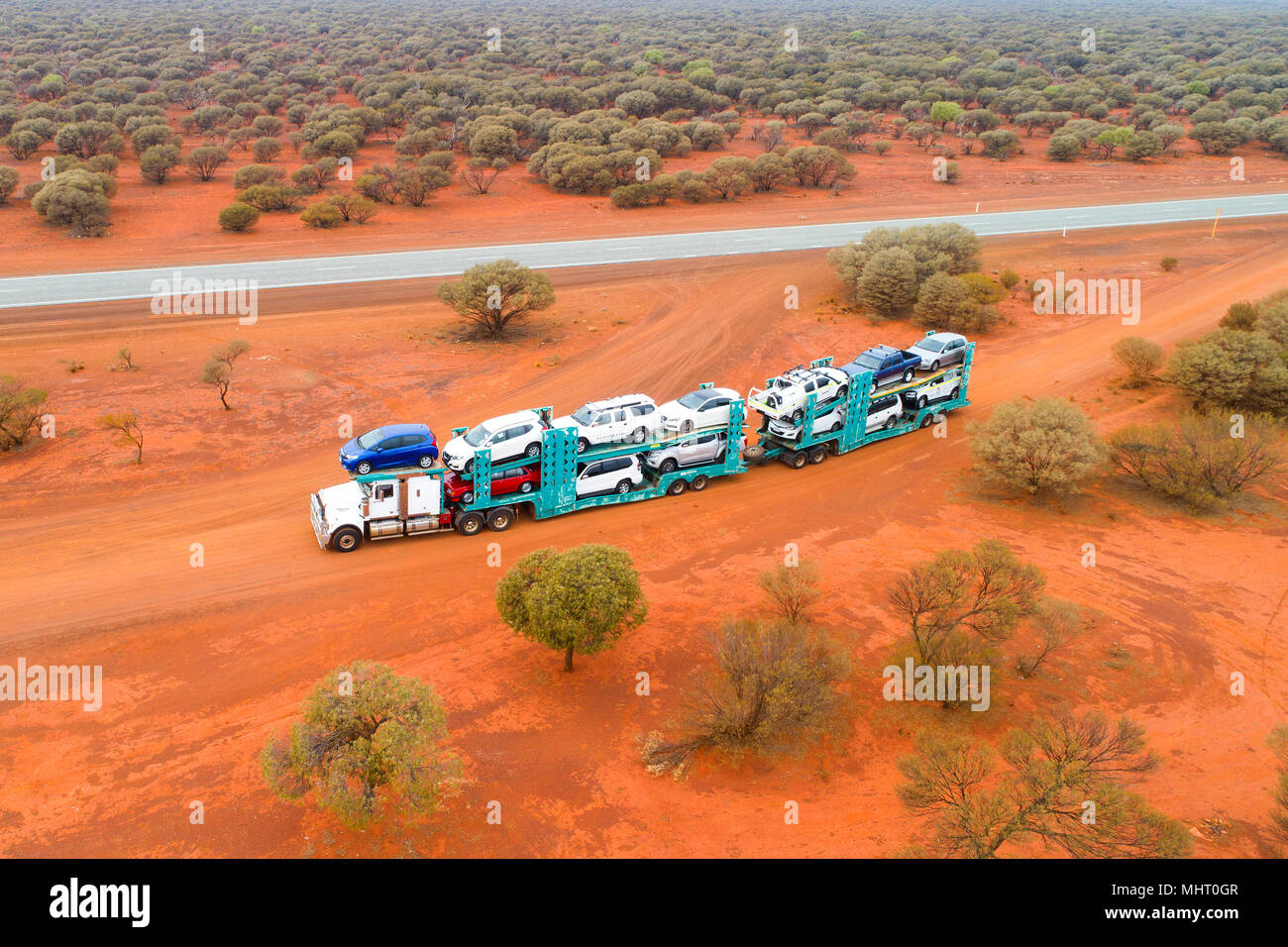 Motor vehicle transport truck on a red dirt road alongside the Great
