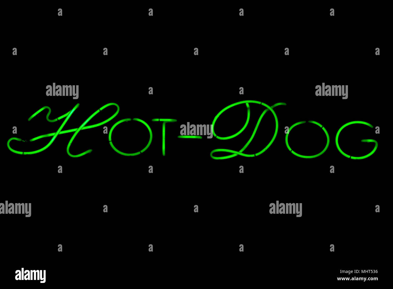 hot dog neon green sign isolated on black background Stock Photo