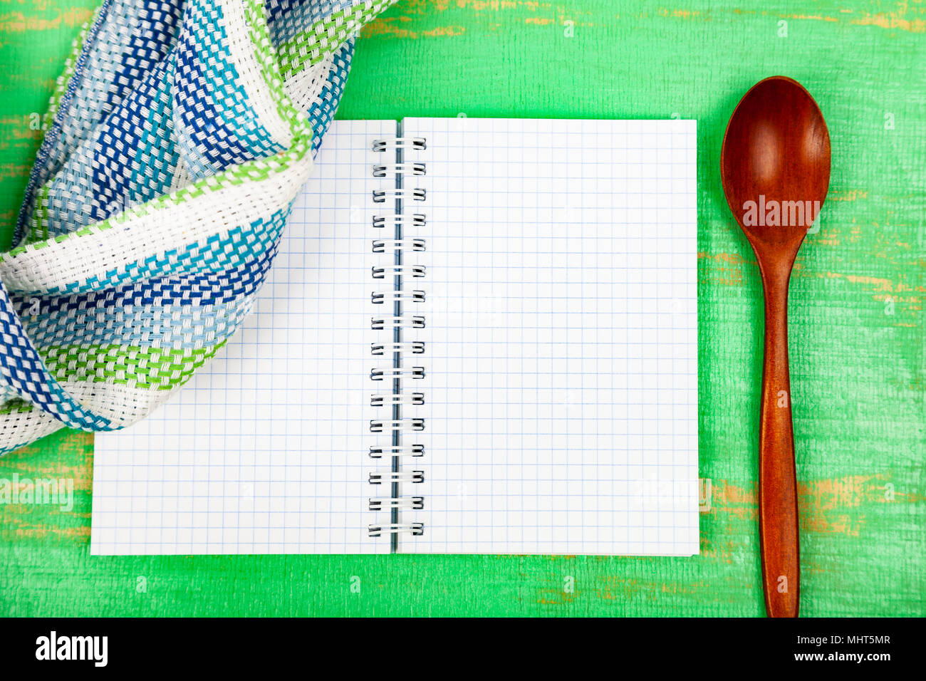 https://c8.alamy.com/comp/MHT5MR/culinary-recipe-towel-and-spoon-on-a-green-wooden-table-cooking-menu-MHT5MR.jpg