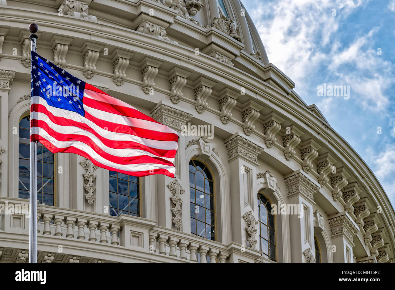 Washington DC Capitol dome detail with waving american flag Stock Photo ...